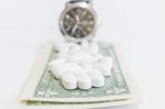 White Pills And Money On White Background Stock Photo