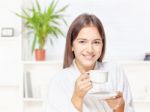 Woman In Bathrobe Relaxing At Home Stock Photo