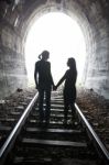 Couple Walking Together Through A Railway Tunnel Stock Photo