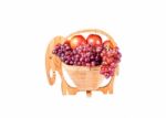 Red Grapes And Apples In Wooden Basket As Elephants Isolated On Stock Photo