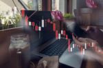 Businessman Is Working With His Computer In Coffee Shop With Sto Stock Photo