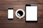 Phone Tablet And Coffee Cup On Wood Table Top View Stock Photo