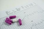 Heap Of Medicine Pills On Cardiogram Grid Paper. Selective Focus Stock Photo