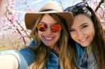 Two Beautiful Young Women Taking A Selfie In The Field Stock Photo