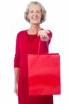 Cheerful Old Woman Holding Shopping Bag Stock Photo