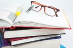 Books Stack With Open Book And Glasses Stock Photo