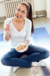 Beautiful Young Woman Eating Cereals At Home Stock Photo