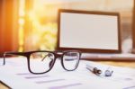 Office Workplace With Laptop And Glasses On Wood Table Stock Photo