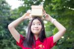 Portrait Of Thai Teen Beautiful Girl In Chinese Dress, Happy New Year And Open Box Gift, Smile And Very Happy Stock Photo