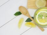 Fresh Lemon In Water, Lemonade And Lemon Slice On White Wood Bac Stock Photo