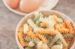 Fusili Pasta In Wooden Plate With Eggs Stock Photo