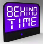 Behind Time Clock Shows Running Late Or Overdue Stock Photo