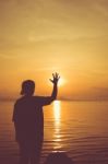 Silhouette Back View Of Woman Relax At Seaside And Showing Stop Stock Photo