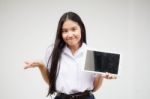 Portrait Of Thai High School Student Uniform Beautiful Girl Using Her Tablet Stock Photo