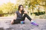 Woman Relaxing After Sports. Hipster Student In The City Park Stock Photo