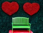 The Green Bench With Red Heart Background Stock Photo