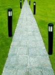 The Stone Block Walk Path With Garden Lamp On Green Grass Background Stock Photo