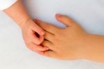 Touching Hands Of Little Girl And Baby Stock Photo