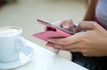 Beautiful Girl Drinking Coffee And Texting With Mobile Phone Stock Photo