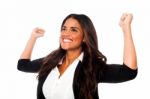 Excited Woman With Arms Raised Stock Photo