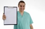 Male Doctor With Empty Notepad Stock Photo