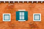 Window On The Orange Brick Wall Stock Photo