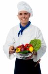 Chef Holding Fresh Vegetables In Strainer Bowl Stock Photo