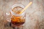 Glass Of Cola With Ice On Wooden Table Stock Photo