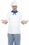 Male Chef Showing Welcome Gesture Stock Photo