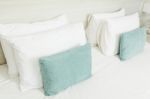 White And Green Pillows On Bed Stock Photo