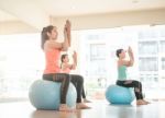 Asian Woman Doing Yoga Indoors Stock Photo