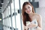 Portrait Of Thai Adult Beautiful Girl Using Her Smart Phone And Smile Stock Photo