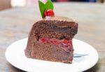 Piece Of Chocolate Cake On White Plate Stock Photo