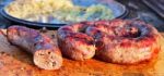 Delicious Sausages On Wooden Plate Cooked On Barbecue Grill Stock Photo