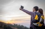 Tourists Look At A Map On The Tablet On Mountain Stock Photo