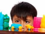 Boy Playing With Colored Dough Stock Photo