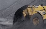 Excavator In Coals Stock Photo