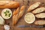 Baguette With Herb Butter And Rosemary Thyme On Rustic Wooden Background Stock Photo