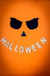 Halloween Word Wooden With Black Eyes On Orange Background Stock Photo