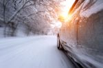 Car And Falling Snow In Winter On Forest Road With Much Snow.(motion Blur) Stock Photo