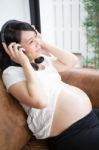 Pregnant Woman Listen To The Music Stock Photo