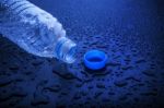 Open Cap Of Empty Platic Bottle Lying On Dark Wet Floor Stock Photo