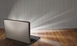 Laptop On Table With Light Out Stock Photo