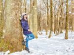 Young Beautiful Woman Walking Under A Snowfall Stock Photo