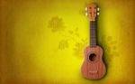 Ukulele On Yellow Background Stock Photo