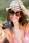 Pretty Young Girl Taking Selfies With Her Smart Phone In The Gar Stock Photo