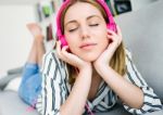 Beautiful Young Woman Listening To Music At Home Stock Photo