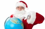 Expressionistic Santa Pointing At North Pole On Globe Stock Photo