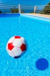 Beach Ball Floating On Water In Swimming Pool Stock Photo