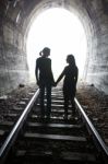 Couple Walking Together Through A Railway Tunnel Stock Photo